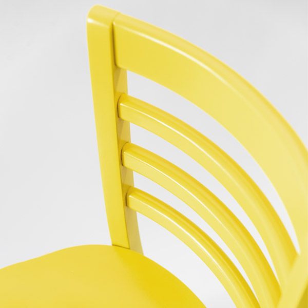 Zoomed in view of the top corner of a yellow Cafe chair